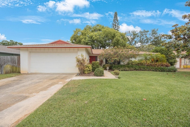 ranch-style house featuring an attached garage, concrete driveway, and stucco siding