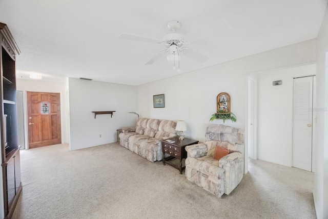 living area featuring carpet and ceiling fan