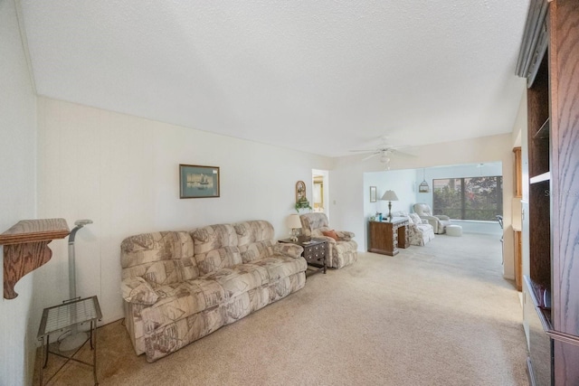 carpeted living area featuring ceiling fan