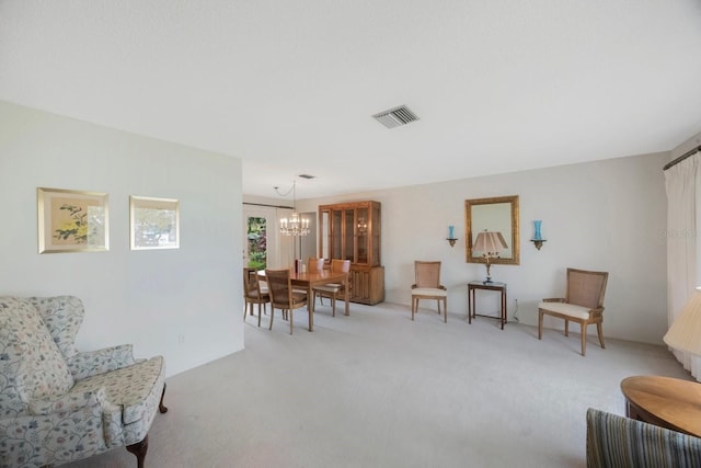 living area featuring a chandelier and carpet