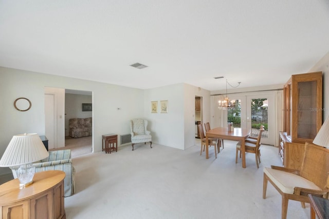sitting room with light colored carpet and a chandelier