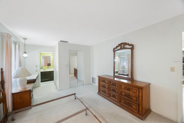 carpeted bedroom with ensuite bath