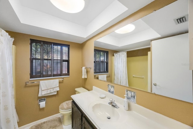 bathroom with a raised ceiling, baseboards, toilet, vanity, and a shower with curtain