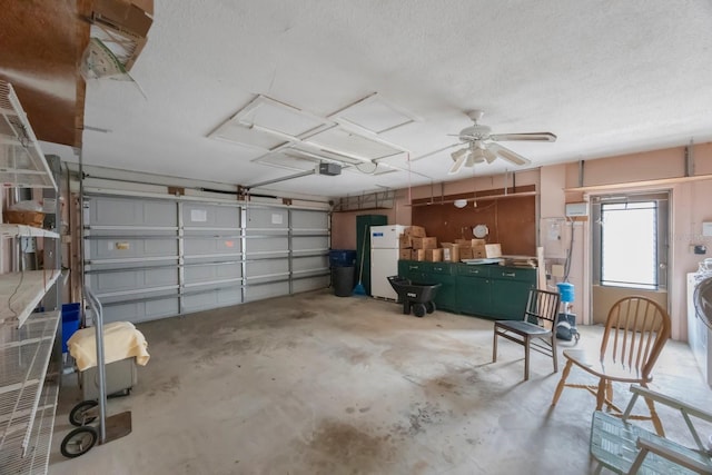 garage with a garage door opener and freestanding refrigerator