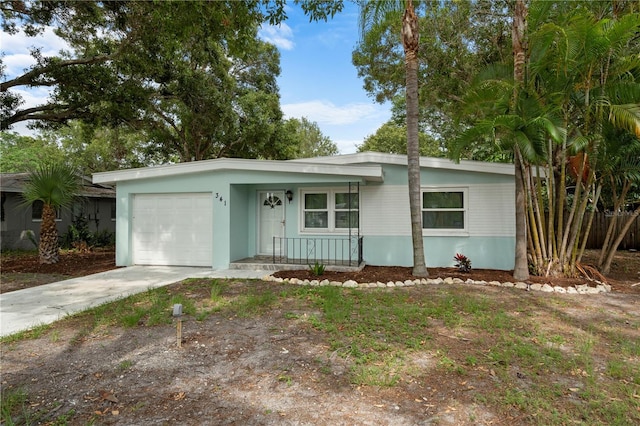 view of front facade featuring concrete driveway, a garage, and a porch