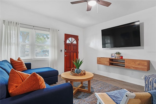 living room with wood finished floors, ceiling fan, baseboards, and vaulted ceiling
