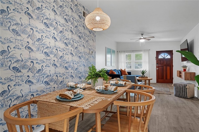 dining room with wood finished floors and ceiling fan