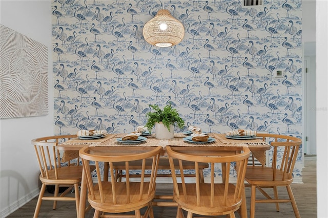 dining space featuring wood finished floors and baseboards