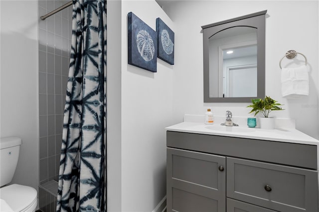 full bathroom with toilet, a stall shower, and vanity
