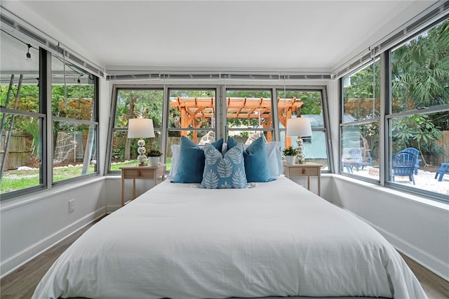 bedroom featuring baseboards and dark wood finished floors