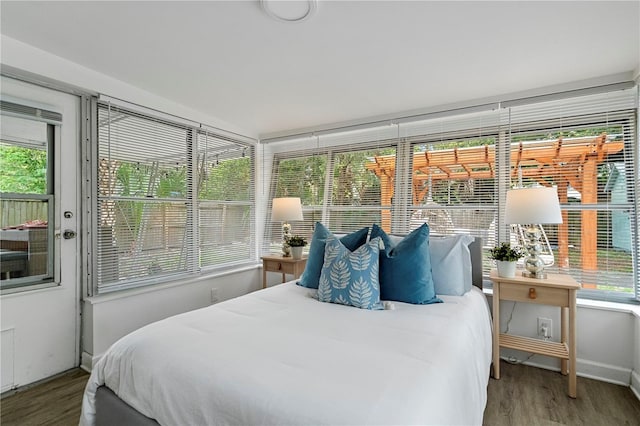 bedroom featuring wood finished floors and baseboards