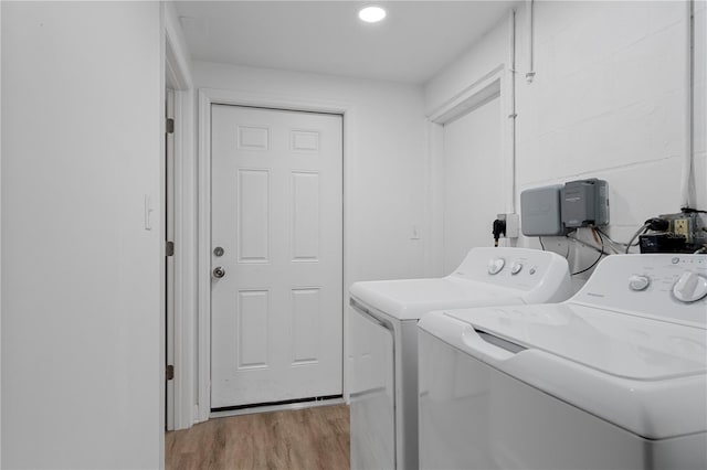 laundry room featuring washing machine and clothes dryer, light wood finished floors, and recessed lighting