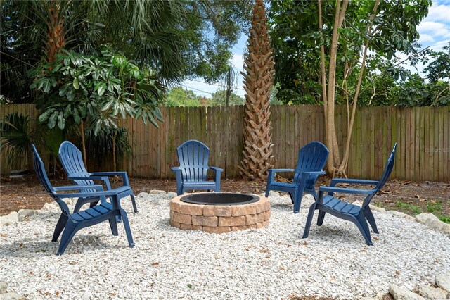 view of patio / terrace with a fire pit and fence