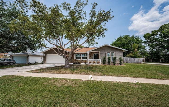 1402 Oleander Dr, Tarpon Springs, FL 34689 - view of front of home featuring concrete driveway, a garage, and stone siding
