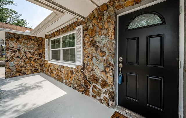 1402 Oleander Dr, Tarpon Springs, FL 34689 - doorway to property with stone siding