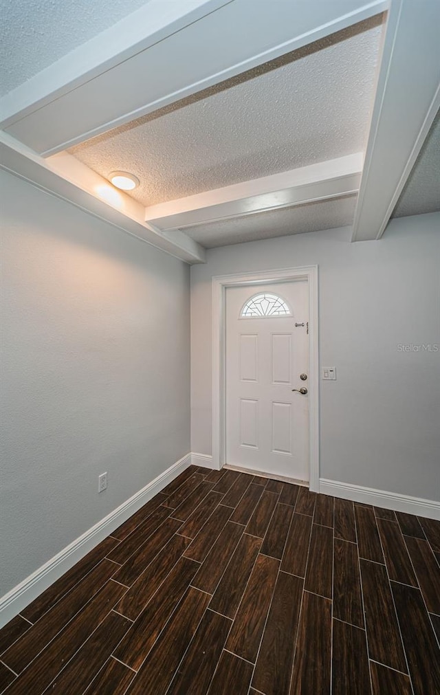 1402 Oleander Dr, Tarpon Springs, FL 34689 - foyer entrance featuring wood finish floors, baseboards, a textured ceiling, and beam ceiling