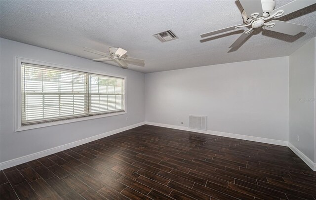 1402 Oleander Dr, Tarpon Springs, FL 34689 - empty room with a ceiling fan, dark wood-style flooring, baseboards, and a textured ceiling