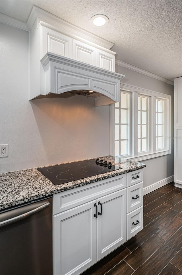 1402 Oleander Dr, Tarpon Springs, FL 34689 - kitchen with black electric cooktop, dishwasher, crown molding, white cabinets, and a textured ceiling