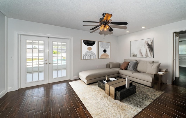 1402 Oleander Dr, Tarpon Springs, FL 34689 - living area featuring dark wood-type flooring, french doors, a textured ceiling, a ceiling fan, and baseboards