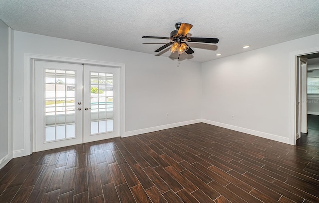 1402 Oleander Dr, Tarpon Springs, FL 34689 - spare room featuring french doors, ceiling fan, dark wood-type flooring, baseboards, and a textured ceiling