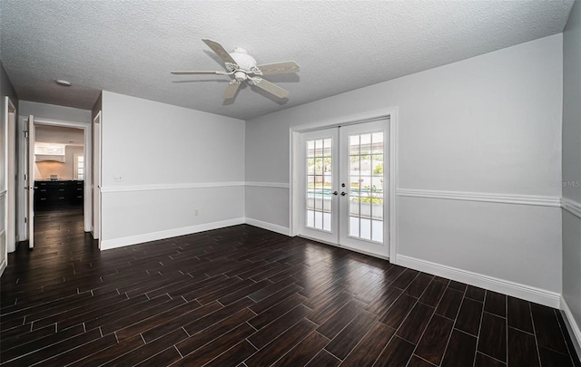 1402 Oleander Dr, Tarpon Springs, FL 34689 - unfurnished room featuring french doors, baseboards, dark wood-style flooring, and a textured ceiling