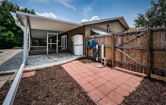 1402 Oleander Dr, Tarpon Springs, FL 34689 - view of patio / terrace with a sunroom, a gate, and fence