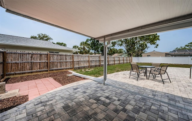 1402 Oleander Dr, Tarpon Springs, FL 34689 - view of patio / terrace featuring a fenced backyard and outdoor dining space