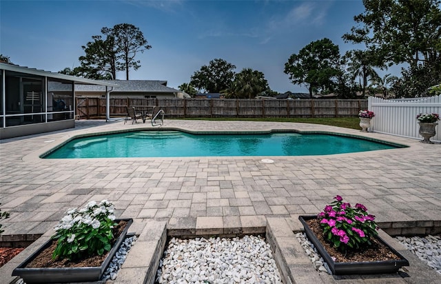 1402 Oleander Dr, Tarpon Springs, FL 34689 - view of swimming pool with a sunroom, a patio, and a fenced backyard