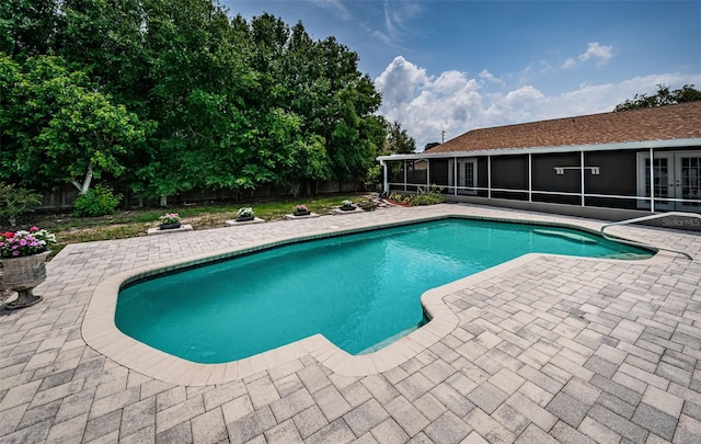 1402 Oleander Dr, Tarpon Springs, FL 34689 - view of swimming pool with a sunroom, french doors, a fenced backyard, and a patio area