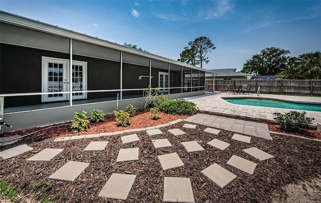 1402 Oleander Dr, Tarpon Springs, FL 34689 - view of swimming pool featuring a sunroom, a fenced backyard, and a patio area
