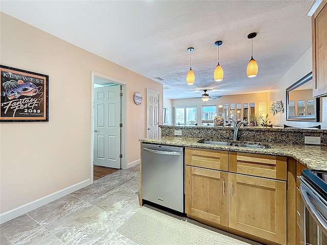230 Medallion Blvd Unit G, Madeira Beach, FL 33708 - kitchen featuring appliances with stainless steel finishes, a sink, baseboards, a ceiling fan, and a peninsula