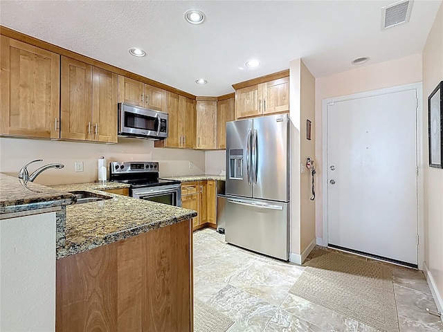 230 Medallion Blvd Unit G, Madeira Beach, FL 33708 - kitchen with appliances with stainless steel finishes, a sink, dark stone countertops, baseboards, and recessed lighting