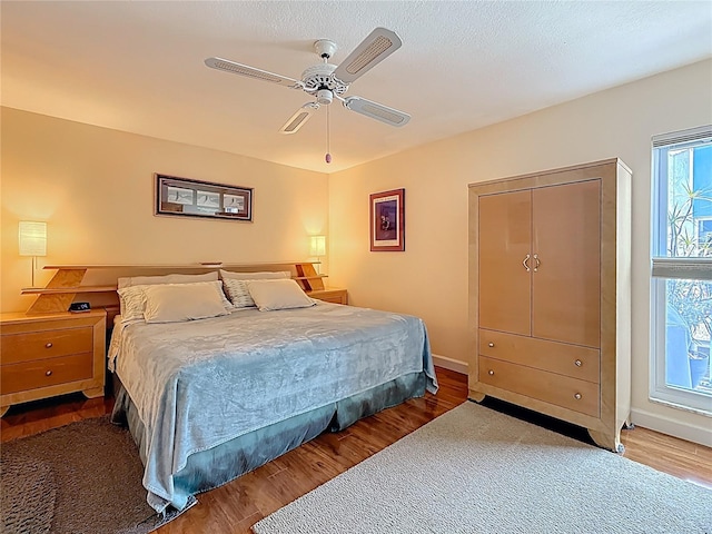 230 Medallion Blvd Unit G, Madeira Beach, FL 33708 - bedroom with wood finished floors, ceiling fan, and baseboards
