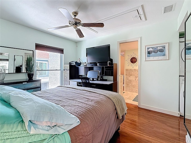 230 Medallion Blvd Unit G, Madeira Beach, FL 33708 - bedroom with wood finished floors, attic access, baseboards, ceiling fan, and connected bathroom