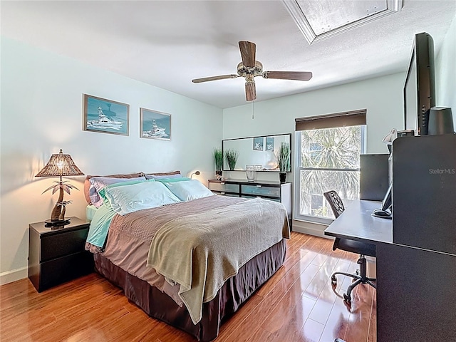 230 Medallion Blvd Unit G, Madeira Beach, FL 33708 - bedroom featuring wood finished floors, an office area, attic access, and ceiling fan
