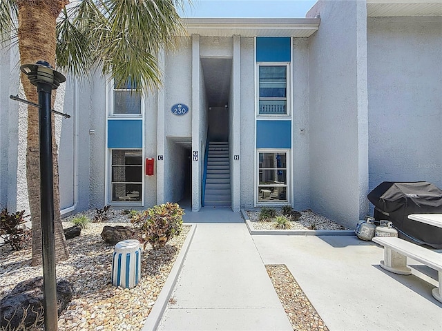 230 Medallion Blvd Unit G, Madeira Beach, FL 33708 - doorway to property featuring stucco siding