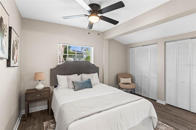 bedroom with multiple closets, wood finished floors, baseboards, and ceiling fan
