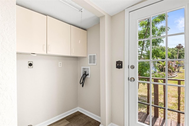 clothes washing area with cabinet space, hookup for a washing machine, hookup for an electric dryer, dark wood finished floors, and baseboards
