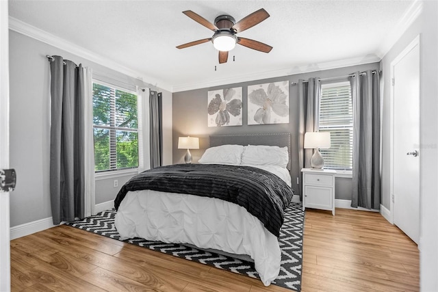 11901 4th St N Unit 8207, Saint Petersburg, FL 33716 - bedroom with crown molding, light wood finished floors, baseboards, and ceiling fan