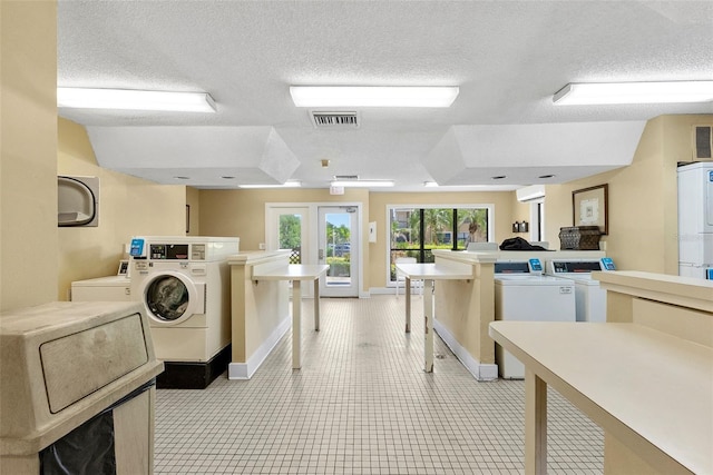 11901 4th St N Unit 8207, Saint Petersburg, FL 33716 - shared laundry with a textured ceiling, washing machine and dryer, and baseboards