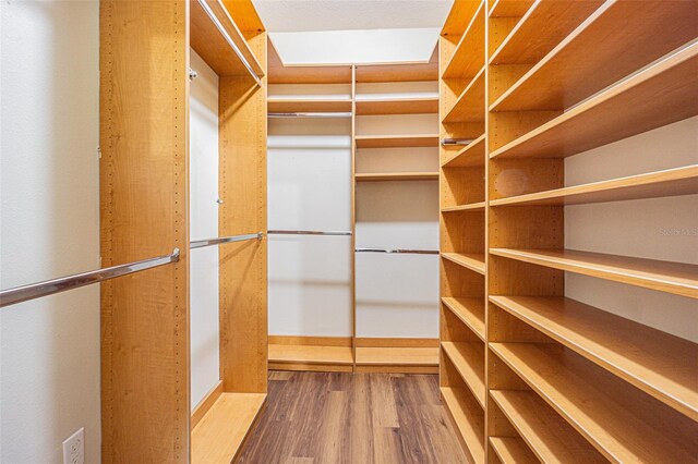 spacious closet with wood finished floors