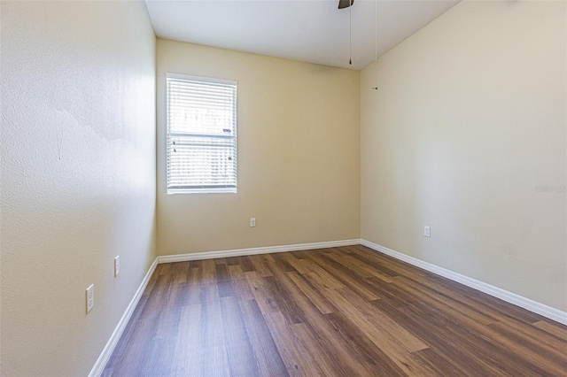 spare room featuring wood finished floors, baseboards, and ceiling fan