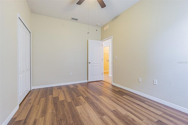 unfurnished bedroom featuring wood finished floors and baseboards