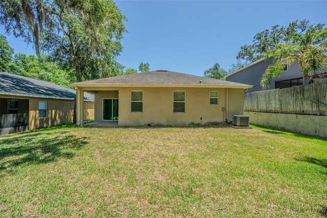 rear view of house featuring stucco siding and central air condition unit