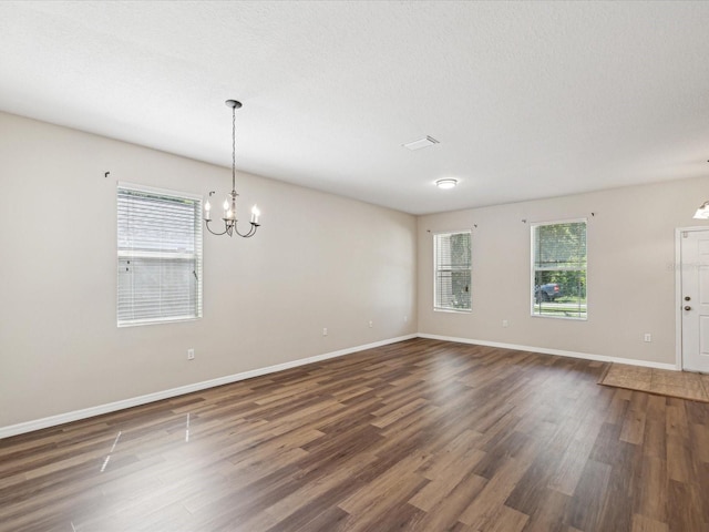 12212 Mcmullen Loop, Riverview, FL 33569 - unfurnished room featuring a chandelier, healthy amount of natural light, wood finished floors, and baseboards