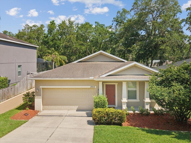 12212 Mcmullen Loop, Riverview, FL 33569 - view of front of house featuring concrete driveway, a garage, a shingled roof, and stucco siding