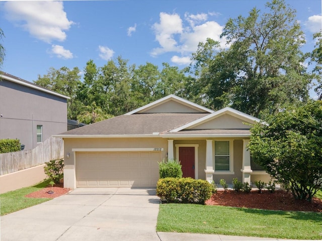 12212 Mcmullen Loop, Riverview, FL 33569 - view of front of home with an attached garage, concrete driveway, stucco siding, and roof with shingles