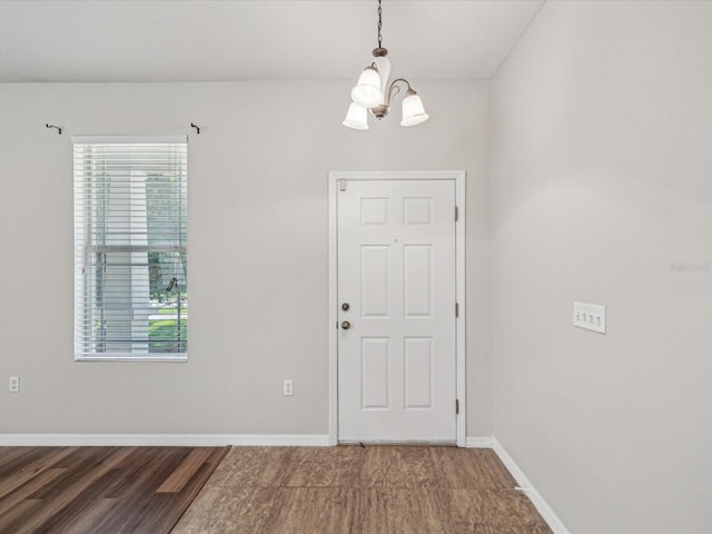 12212 Mcmullen Loop, Riverview, FL 33569 - entryway featuring a chandelier, wood finished floors, and baseboards