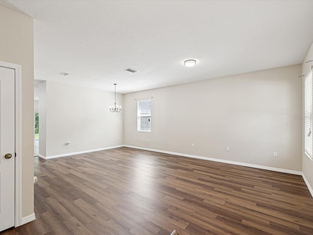 12212 Mcmullen Loop, Riverview, FL 33569 - unfurnished room with a chandelier, dark wood-style floors, and baseboards