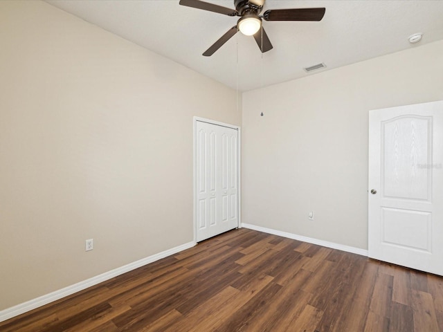 12212 Mcmullen Loop, Riverview, FL 33569 - empty room featuring dark wood-type flooring, ceiling fan, baseboards, and a smoke detector